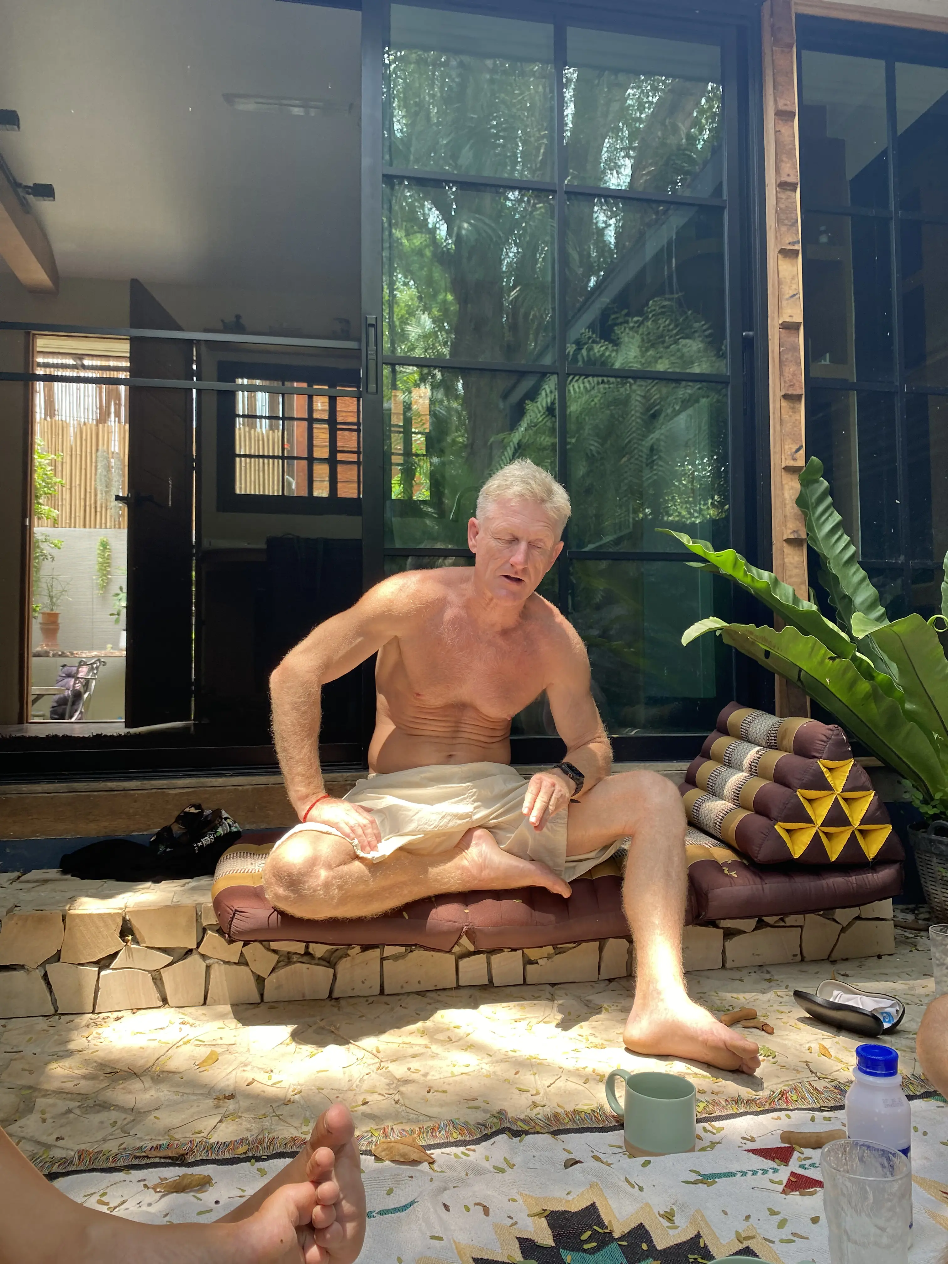 A guest relaxing in the courtyard lounge at Zen Pod