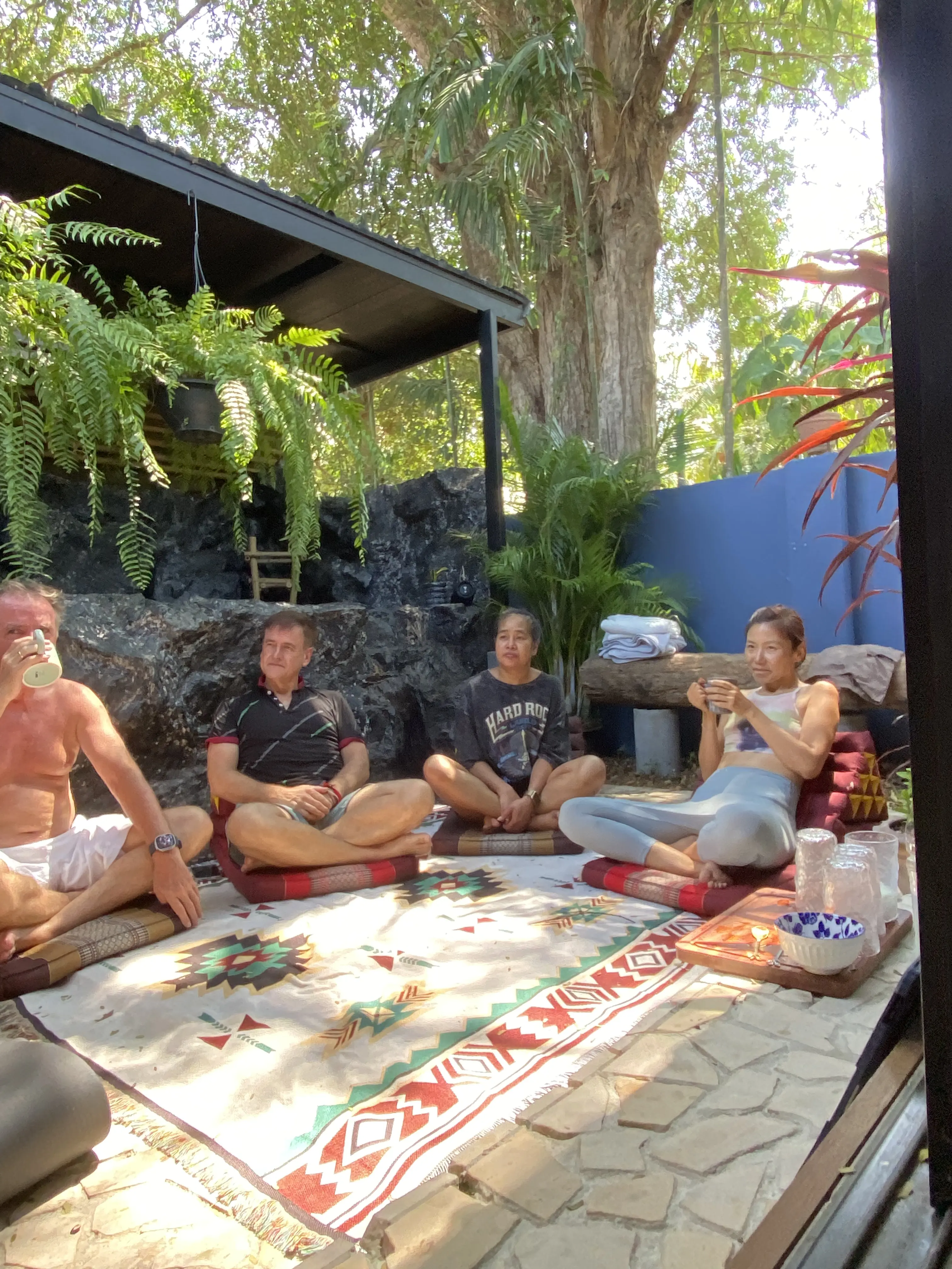 A group session on the shaded patio at Zen Pod